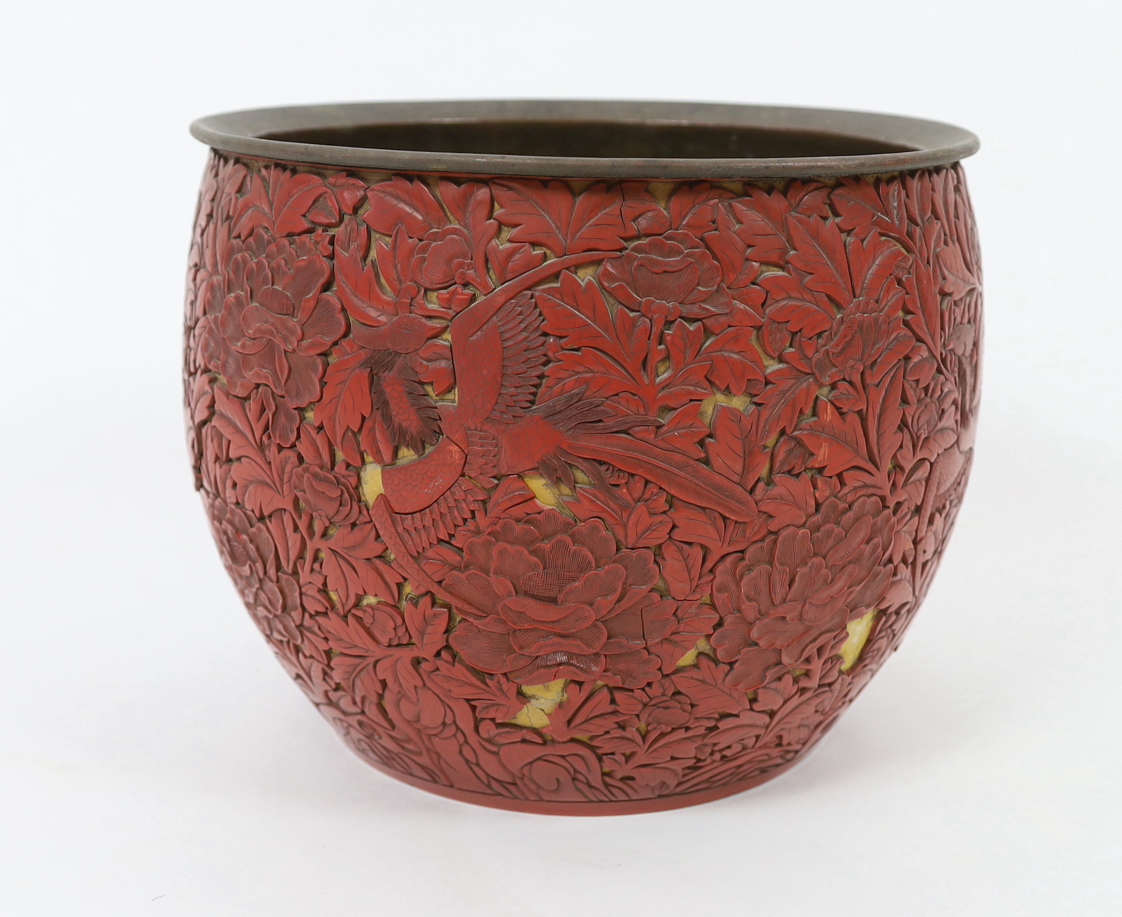 A large Chinese cinnabar lacquer ‘pheasant and peony’ jardiniere, 19th century, losses and numerous loose sections